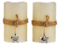 Two beige LED candles with twine and a star pendant.