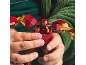 Child's hands playing with a red and gold toy superhero figure.