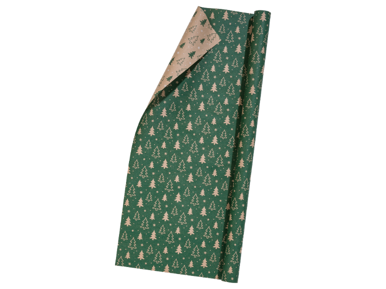 Roll of Christmas wrapping paper with fir trees and snowflakes on a green background.