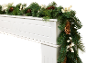Christmas garland with pinecones and white berries on a white fireplace mantel.