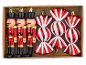 Christmas ornament set: three nutcrackers and three red and white striped candies.