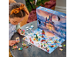 Girl playing with a toy advent calendar featuring a castle and figurines.