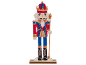Wooden nutcracker figure in red, blue, and gold, standing on a base.