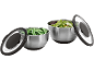 Two stainless steel bowls with lids, one with snap peas and the other with salad.