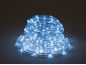 Coiled LED rope light, emitting a cool white glow.