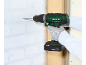 Person drilling into a wall with a cordless drill