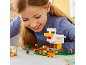 Girl playing with a building toy set featuring a large chicken, a fox, and human figures.