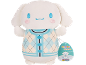 White plush toy with blue and beige argyle vest, with cartoon character tag.