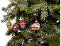Christmas tree with decorative ornaments shaped like an ice cream, donut, cupcake, and cake.