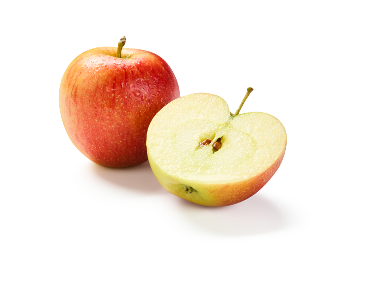 Whole and halved red apples with water droplets, showing seeds.