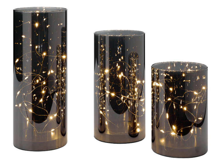 Three decorative glass cylinders with warm white LED fairy lights on a black background.