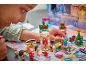 Child playing with Disney-themed building blocks, featuring figures and small structures.