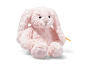 Plush pink bunny sitting on a white background
