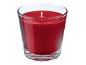 Red scented candle in a glass jar.