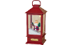 Red Christmas lantern with Santa Claus figurine, holding a tree and a lantern, surrounded by snow.