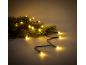 Christmas lights with warm yellow glow intertwined with green pine branches.