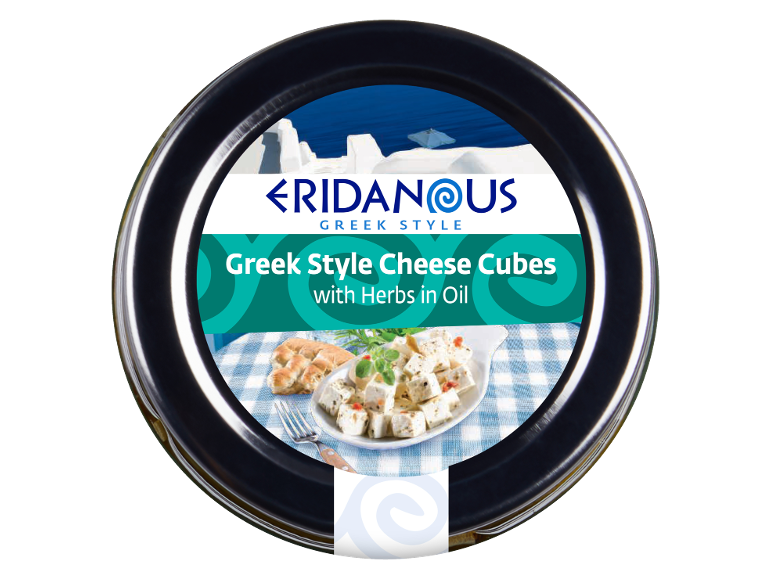 Greek style cheese cubes with herbs in oil, served on a blue and white checkered cloth.