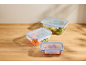 Silvercrest glass food storage containers with fresh food on a wooden surface.