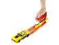Yellow toy race car on a track with a hand-activated launcher.