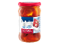 Red chili peppers stuffed with soft cheese in a glass jar, Greek style.