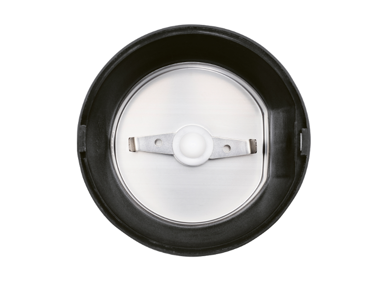 Inside of a coffee grinder with a blade and stainless steel bowl.