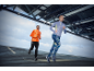 Two runners in long-sleeved tops and athletic pants, running outdoors.