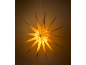 Suspended wooden light star, emitting a warm glow.