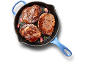 Three juicy steaks cooked in a blue cast iron skillet with garlic and herbs.