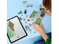 Child building a toy block set with a tablet displaying building instructions.