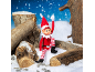 Christmas elf sitting on snowy logs.