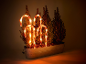 Lighted candy canes in a planter with shrubs, Christmas decoration.