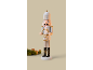 White wooden nutcracker with gold details, fir branches, and walnuts.