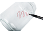 A clear glass jar with a red wavy line drawn by a marker pen.