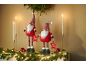 Two Christmas gnomes with 'Merry Christmas' text, candles, and garland.