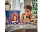 Boy playing with a space-themed advent calendar and small toy figures.