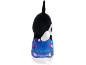 Black plush toy in blue overalls with colorful patterns and pink buttons.