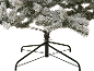 Flocked artificial Christmas tree with a green stand.