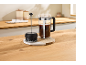 Coffee press and milk frother on a wooden kitchen counter.
