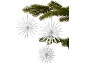 Three white paper snowflake ornaments hanging from a fir branch.