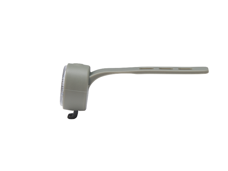 Grey bicycle light with a strap on a black background.