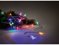 Fir branches with colorful Christmas lights on a dark background.