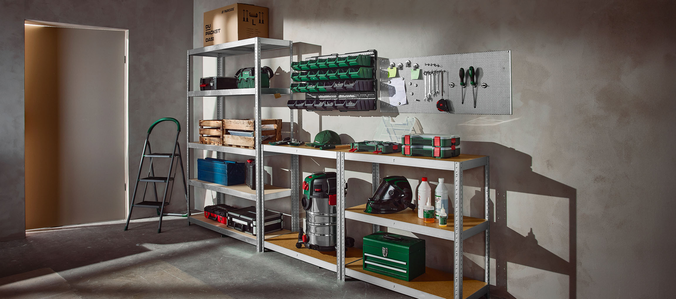 Well-organized garage with metal shelving, toolboxes, and a pegboard.