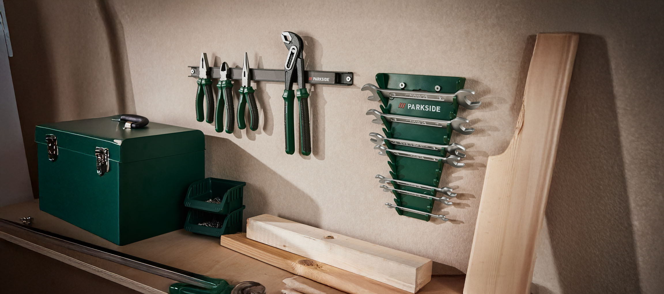 Parkside tools neatly organized on a workshop wall and shelf.