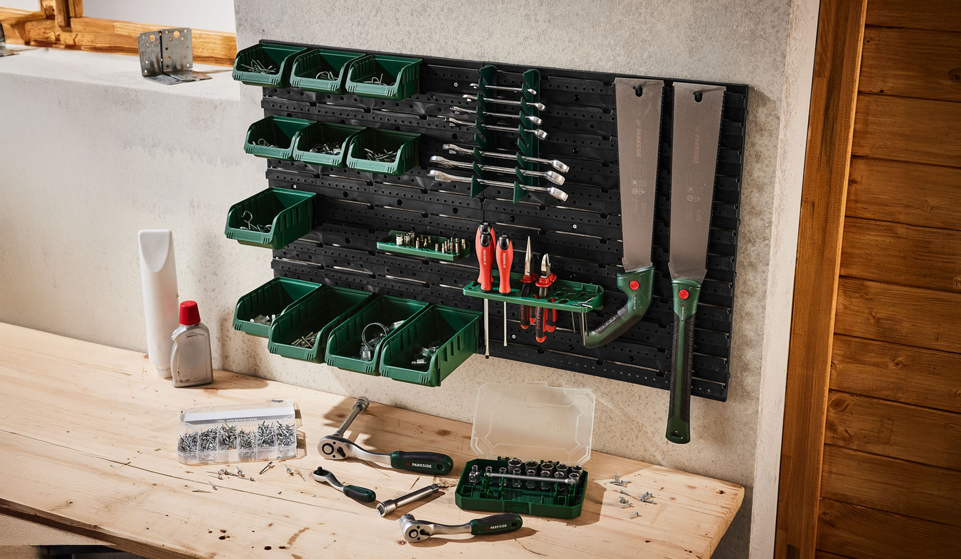 Parkside wall-mounted tool organizer with bins and tools.