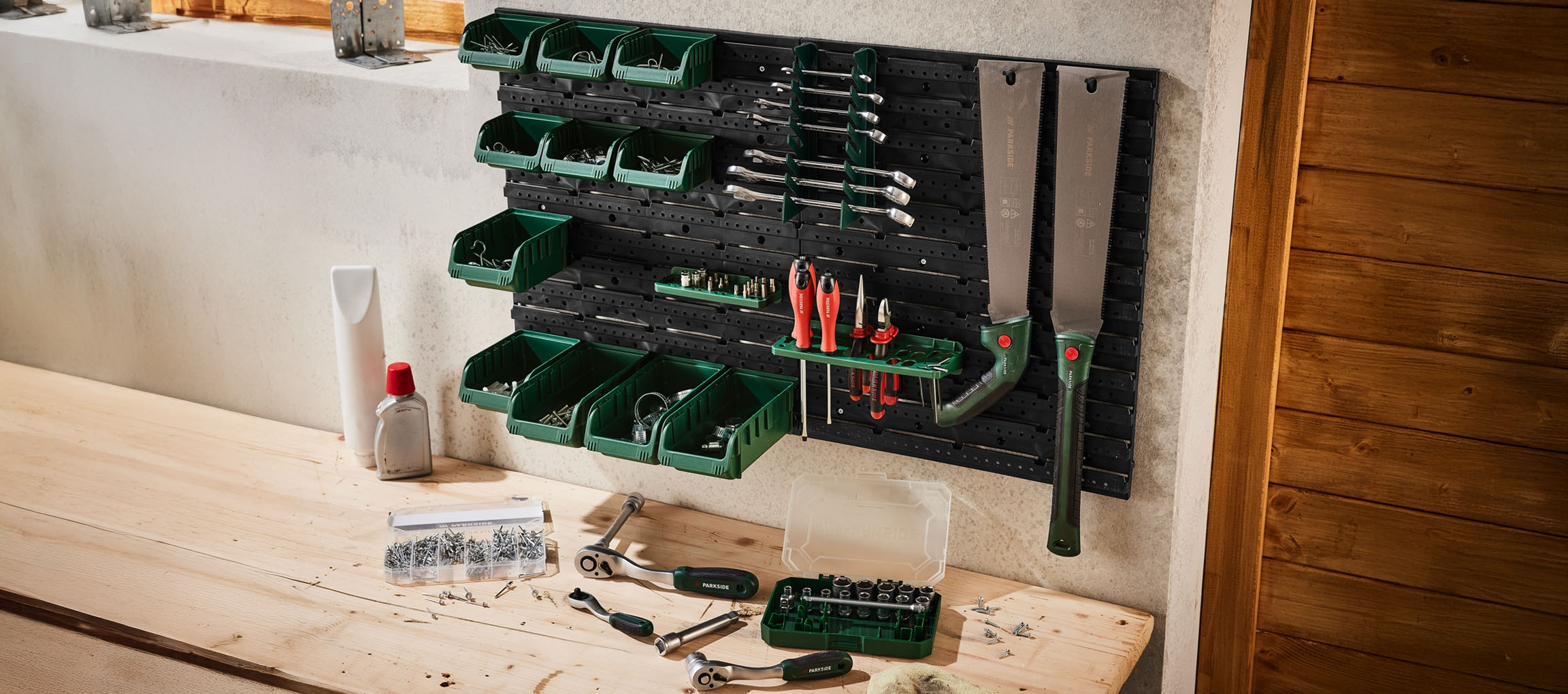 Parkside wall-mounted tool organizer with various tools and storage bins.