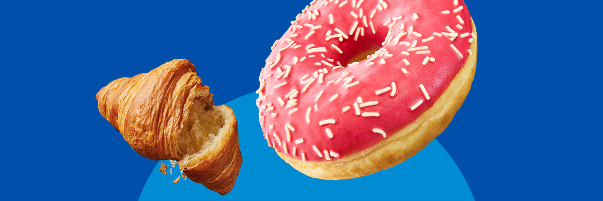 A croissant and a pink frosted donut with sprinkles on a blue background.