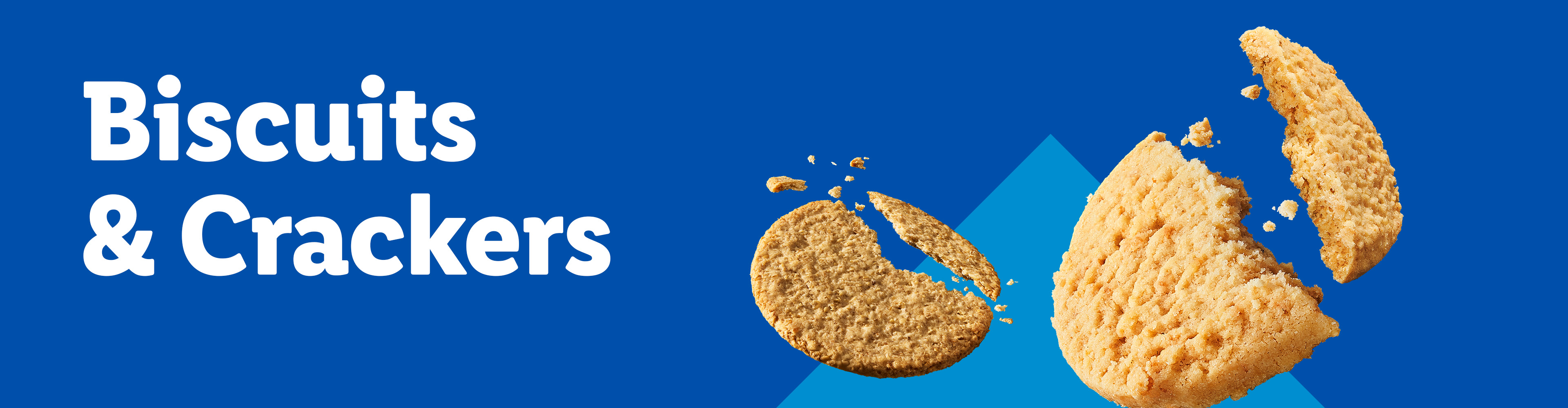 Two broken cookies with crumbs against a blue background with a subtle triangle.