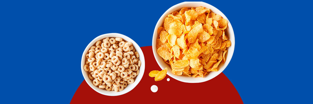 Two bowls of cereal: one with oat rings, one with corn flakes, on a blue and red background.