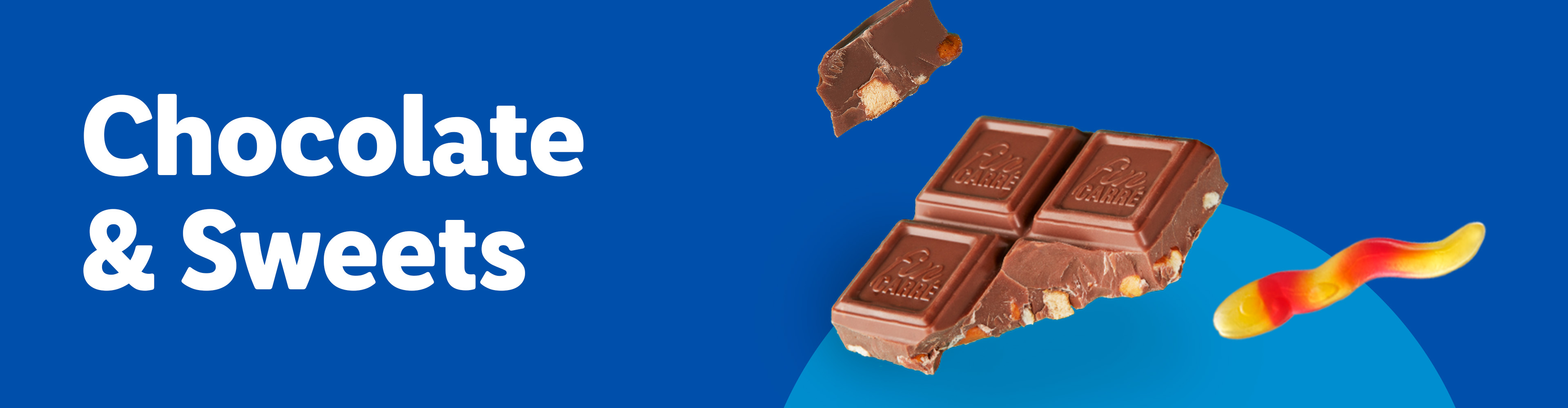 Chocolate bar pieces with nuts and a red and yellow gummy candy on a blue background.