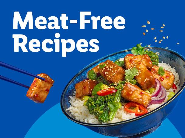 A bowl of meat-free stir-fry with rice, vegetables, and a piece held by chopsticks.